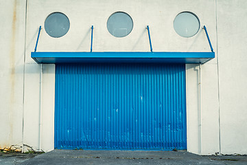 Image showing Blue gate on a grungy wall