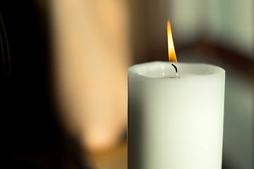 Image showing Large candle with a burning flame