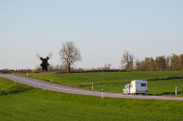 Image showing Car with caravan in a green landscape