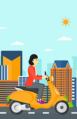 Image showing Woman riding scooter.