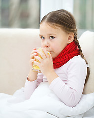 Image showing Ill little girl is drinking vitamin cocktail