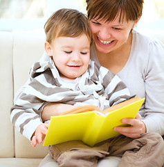 Image showing Mother is reading book for her son