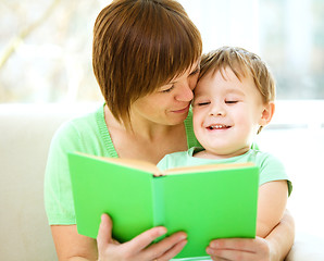 Image showing Mother is reading book for her son