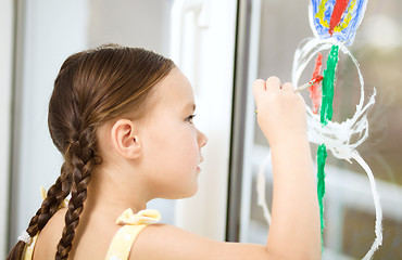 Image showing Portrait of a cute girl playing with paints