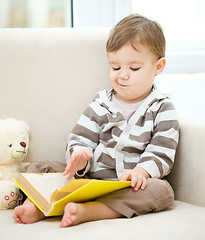 Image showing Little boy is reading book