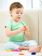 Image showing Little boy playing with toys