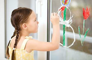 Image showing Portrait of a cute girl playing with paints