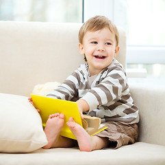 Image showing Little boy is reading book