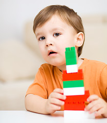 Image showing Boy is playing with building blocks