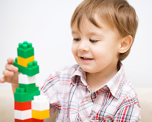 Image showing Boy is playing with building blocks