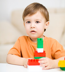 Image showing Boy is playing with building blocks