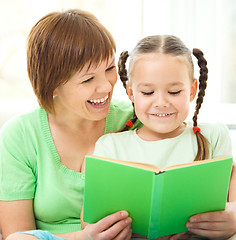 Image showing Mother is reading book for her daughter