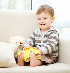 Image showing Little boy is reading book