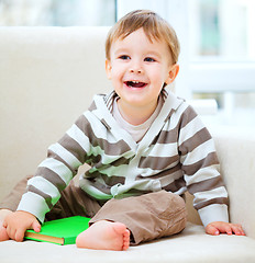 Image showing Little boy is reading book