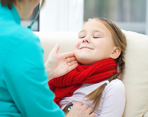 Image showing Doctor is examining little girl