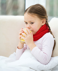 Image showing Ill little girl is drinking vitamin cocktail