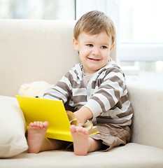 Image showing Little boy is reading book