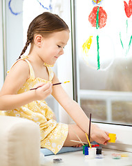 Image showing Portrait of a cute girl playing with paints