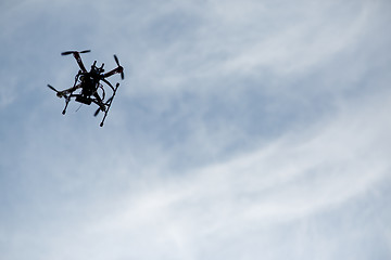 Image showing flying drone with camera on the sky