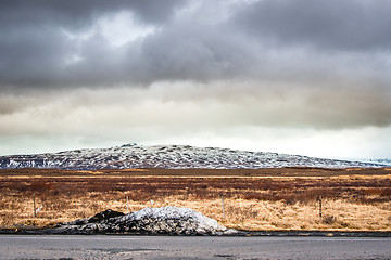 Image showing Snow by a road in dramatic scenery