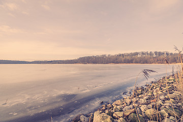 Image showing Frozen river landscape with pebbles