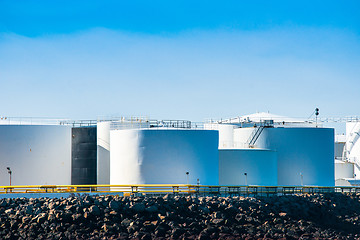 Image showing Silos by the sea in blue sky