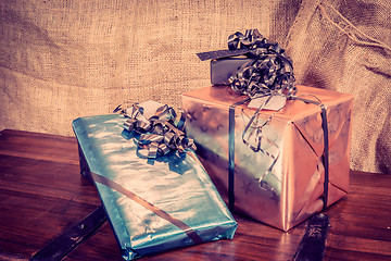 Image showing Shiny gift boxes on a wooden table