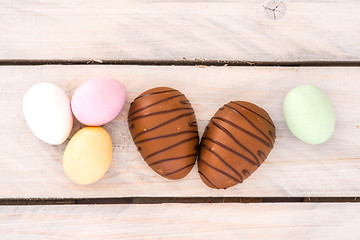 Image showing Easter candy eggs on a wooden table