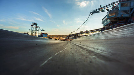 Image showing Long conveyor belt transporting ore