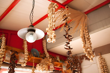 Image showing Garlic and Peppers Hanging from Ceiling In Market