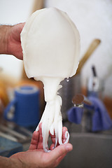 Image showing Person cleaning a raw baby octopus or squid