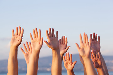 Image showing Unrecognizable people pulling hands in the air