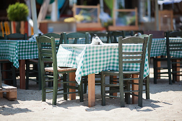 Image showing Empty Tables and Chairs on Sunny Restaurant Patio