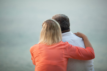Image showing Couple with Arms Around Each Other Admiring Sunset