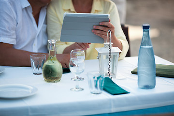 Image showing Middle-aged couple using a tablet at the table