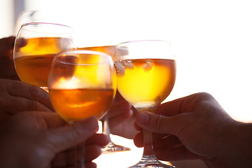 Image showing Several people clinking glasses with cold drinks