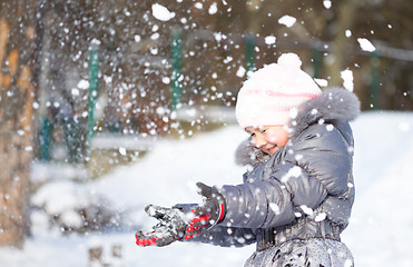 Image showing Little girl is throwing snow