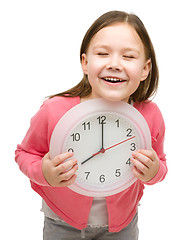 Image showing Little girl is holding big clock