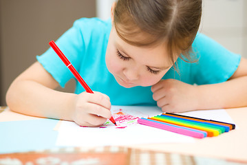 Image showing Cute cheerful child drawing using felt-tip pen