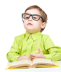 Image showing Little child play with book