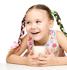 Image showing Cute little girl with a glass of milk