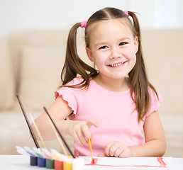 Image showing Cute cheerful child play with paints