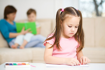 Image showing Little girl is playing with plasticine