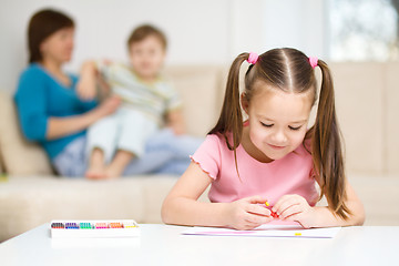 Image showing Little girl is playing with plasticine