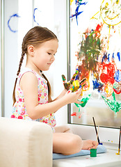 Image showing Portrait of a cute girl playing with paints