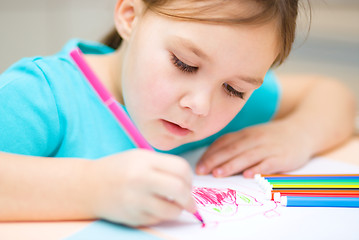 Image showing Cute cheerful child drawing using felt-tip pen