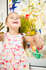 Image showing Portrait of a cute girl playing with paints