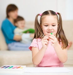 Image showing Little girl is playing with plasticine