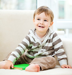 Image showing Little boy is reading book