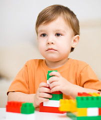 Image showing Boy is playing with building blocks